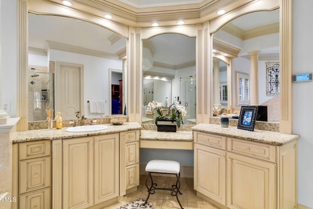 bathroom featuring crown molding, a shower with door, tile patterned flooring, decorative columns, and vanity