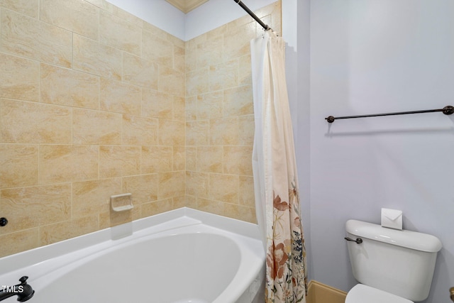 bathroom featuring shower / tub combo and toilet