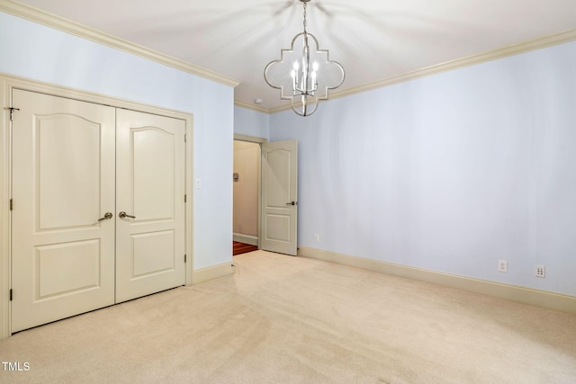 interior space with an inviting chandelier, light colored carpet, and ornamental molding