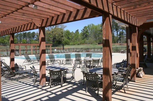 view of patio / terrace featuring a community pool and a pergola