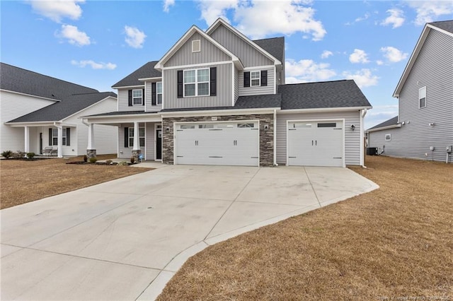 craftsman inspired home featuring a garage, a front lawn, and a porch