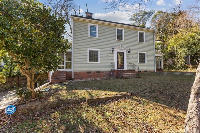 colonial-style house with a front lawn