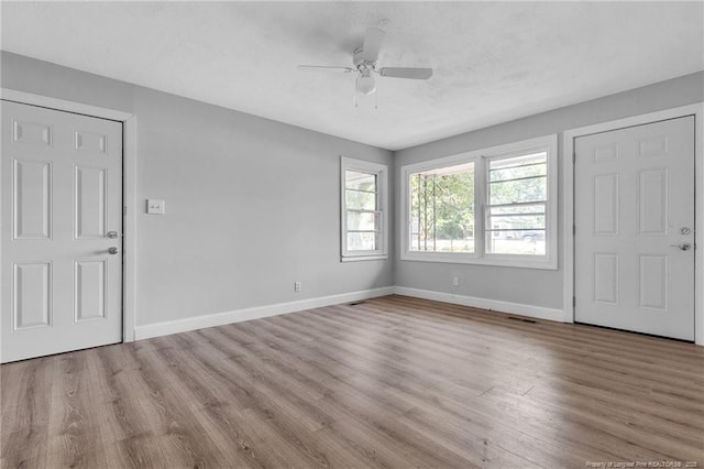 foyer entrance featuring ceiling fan and light wood-type flooring