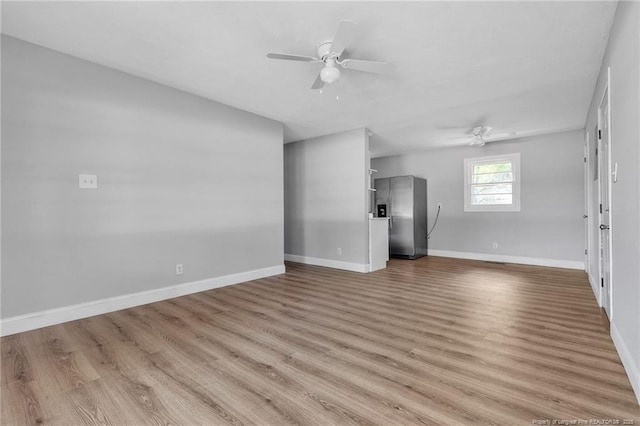 unfurnished living room with ceiling fan and light wood-type flooring