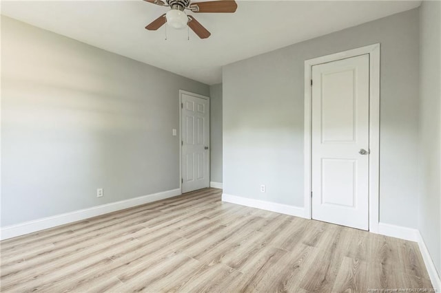 empty room with ceiling fan and light wood-type flooring