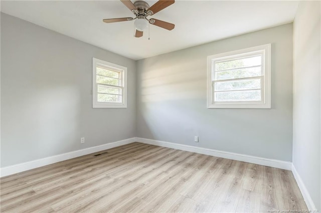 empty room with ceiling fan and light hardwood / wood-style flooring