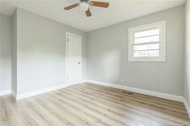 empty room with ceiling fan and light wood-type flooring