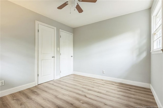 unfurnished bedroom with light wood-type flooring and ceiling fan