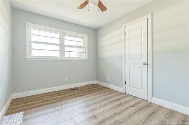 empty room with light hardwood / wood-style floors and ceiling fan