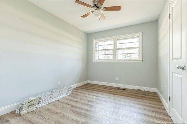 empty room with ceiling fan and light wood-type flooring