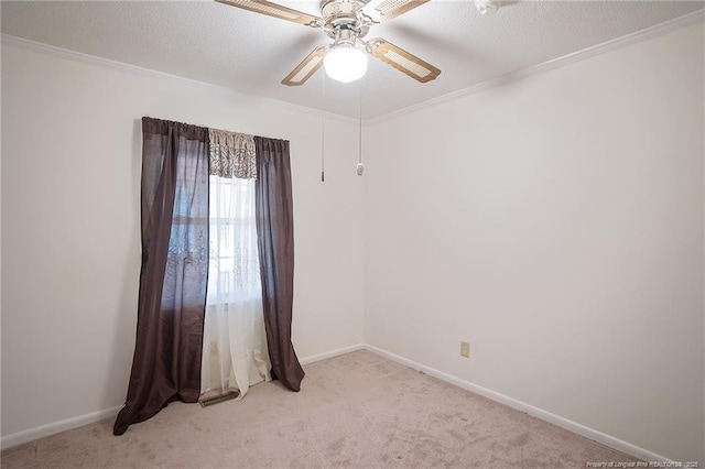 empty room featuring light carpet, crown molding, a textured ceiling, and ceiling fan