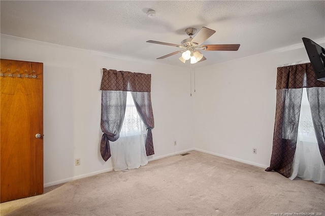 carpeted empty room with a textured ceiling and ceiling fan