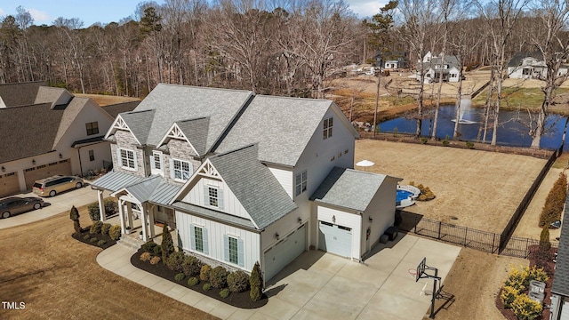 birds eye view of property with a water view and a residential view