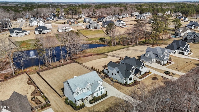 birds eye view of property featuring a water view and a residential view