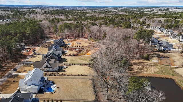 aerial view featuring a residential view, a water view, and a forest view