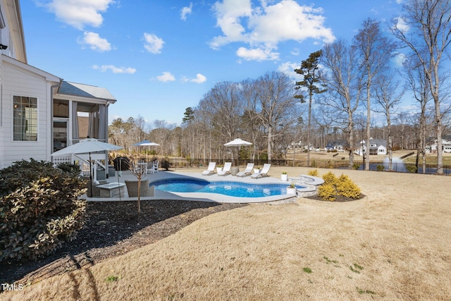 view of swimming pool with a lawn, a patio area, fence, and a fenced in pool