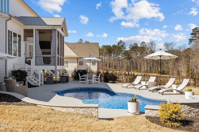 view of pool featuring a sunroom, fence, a fenced in pool, and a patio