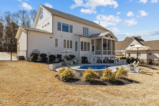 back of property with a fenced in pool, a sunroom, fence, and a patio