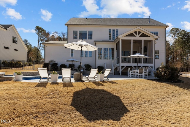 back of property with a ceiling fan, a sunroom, a patio, and fence