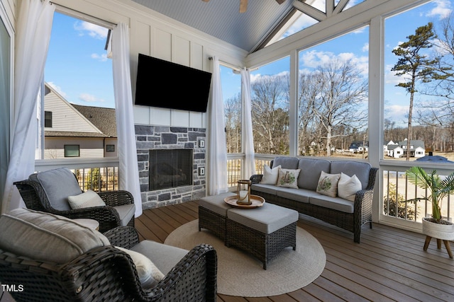 sunroom / solarium with a fireplace and vaulted ceiling