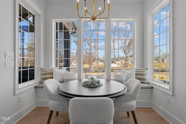 dining room featuring baseboards, an inviting chandelier, and wood finished floors