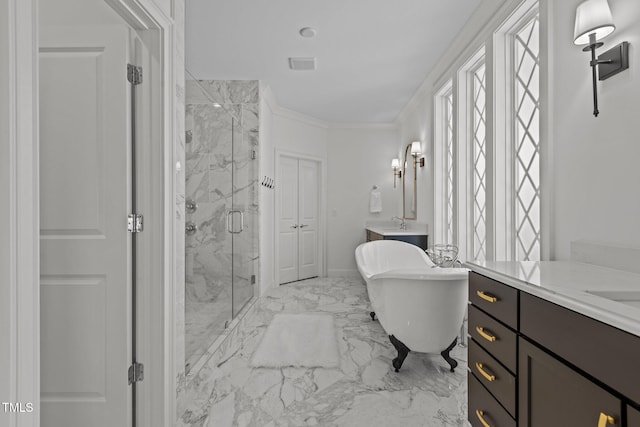 bathroom with a marble finish shower, marble finish floor, crown molding, vanity, and a freestanding tub