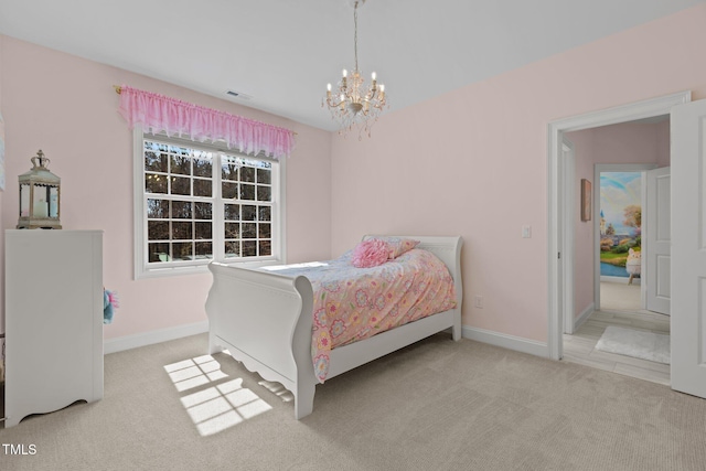 carpeted bedroom with baseboards, visible vents, and a notable chandelier