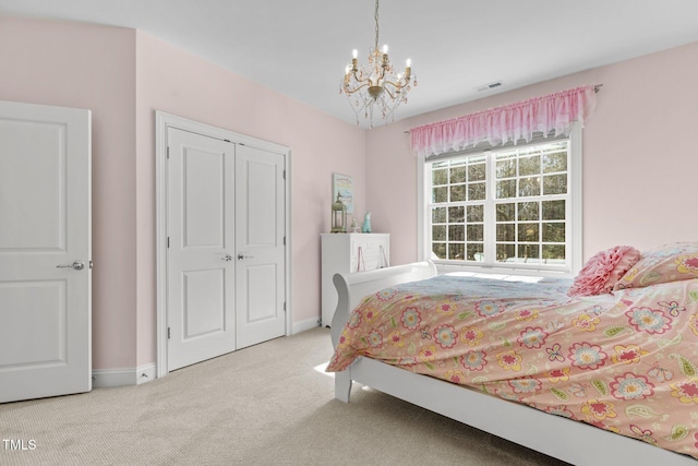 bedroom with a notable chandelier, a closet, visible vents, carpet flooring, and baseboards