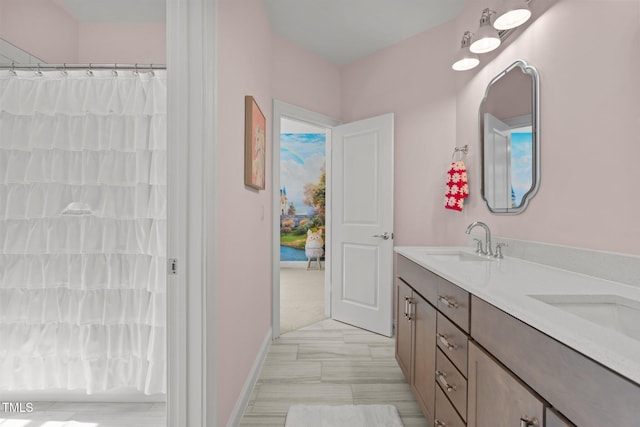 full bath featuring a sink, a shower with shower curtain, and double vanity