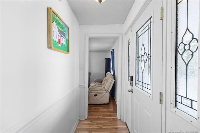 corridor featuring wood-type flooring