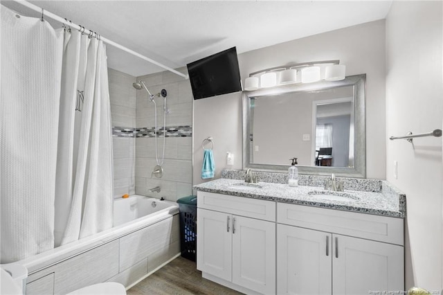 bathroom featuring vanity, hardwood / wood-style floors, and shower / bath combo