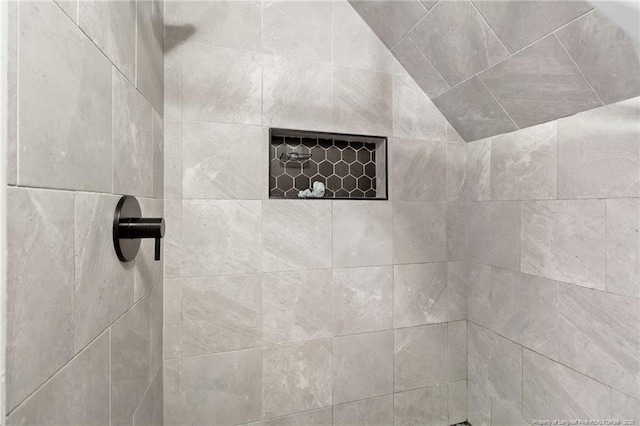 bathroom with tiled shower