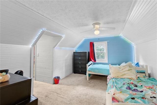 carpeted bedroom featuring lofted ceiling, a textured ceiling, and ceiling fan