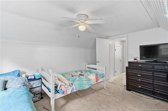 bedroom featuring ceiling fan, lofted ceiling, and light colored carpet