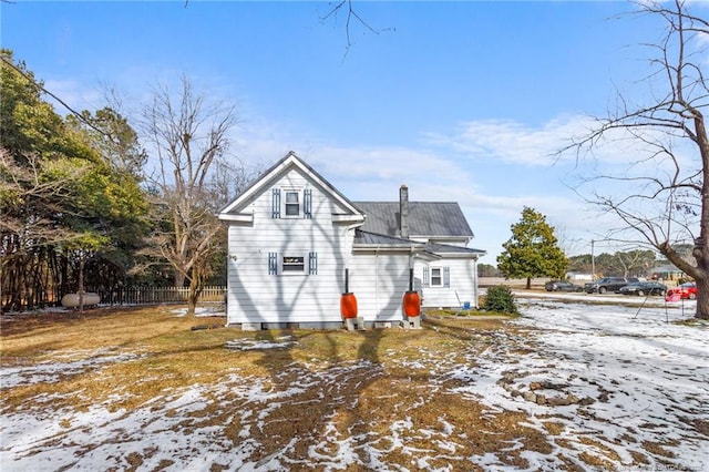 view of snow covered back of property