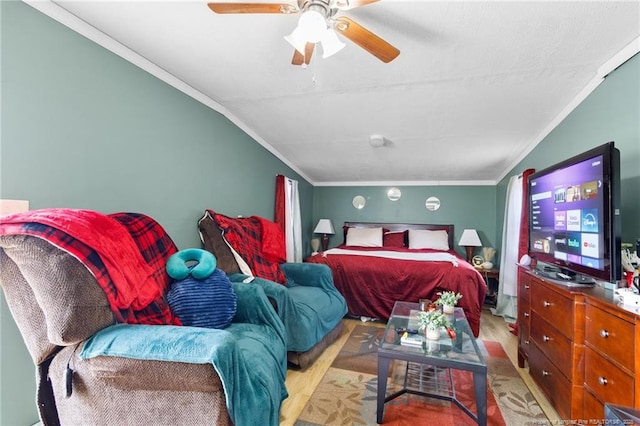 bedroom with lofted ceiling, crown molding, ceiling fan, and light wood-type flooring