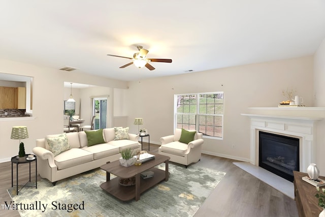 living room featuring hardwood / wood-style floors and ceiling fan