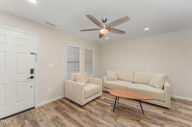 living room featuring ceiling fan and hardwood / wood-style floors