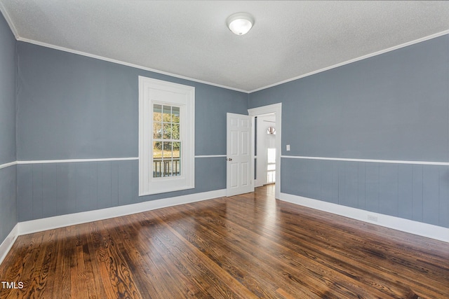 empty room featuring crown molding, dark hardwood / wood-style floors, and a textured ceiling