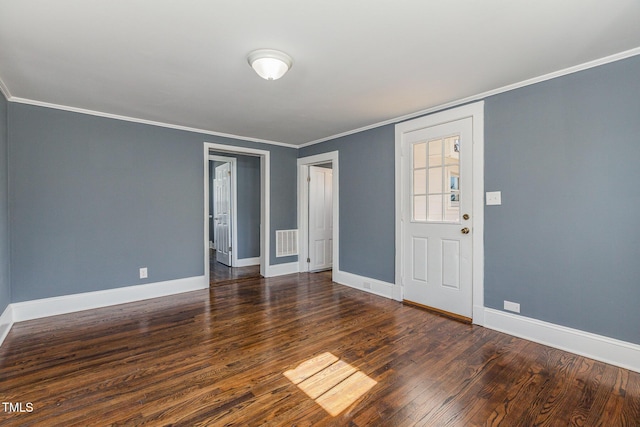 unfurnished room featuring baseboards, dark wood finished floors, and crown molding