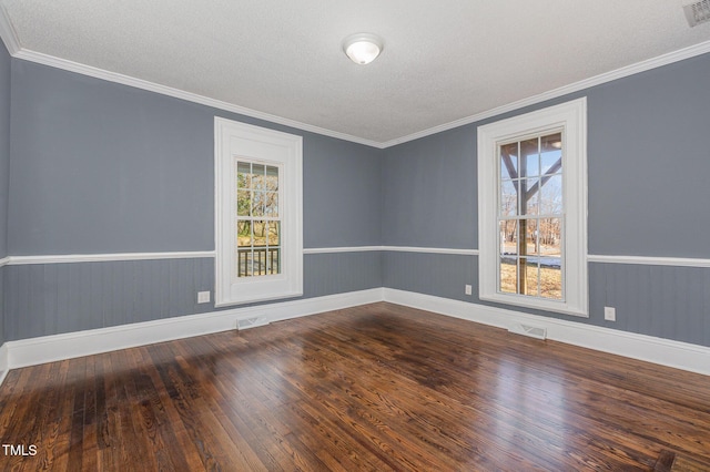 empty room with crown molding, hardwood / wood-style floors, and a textured ceiling