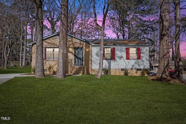 ranch-style home with a lawn