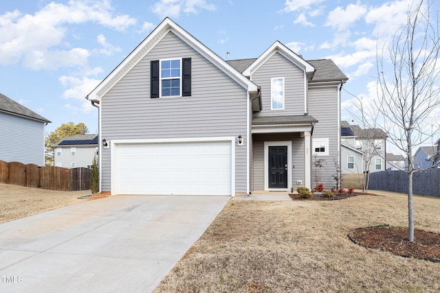 view of property with a garage and a front lawn