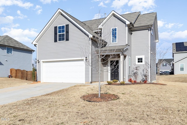 view of property with a garage and a front yard