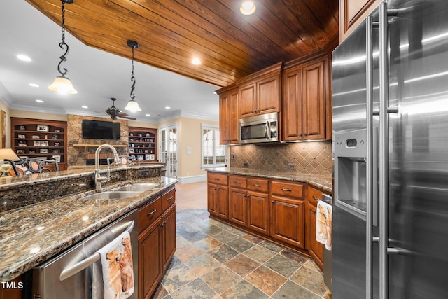 kitchen with sink, wooden ceiling, appliances with stainless steel finishes, pendant lighting, and dark stone counters