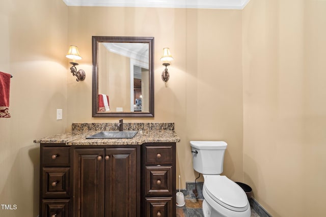 bathroom with vanity, ornamental molding, and toilet