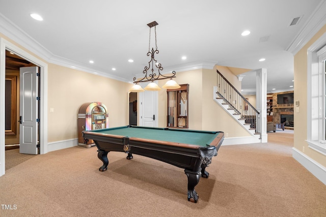 game room with crown molding, a stone fireplace, light carpet, and pool table