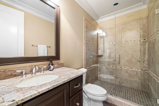 bathroom with ornamental molding, vanity, toilet, and an enclosed shower