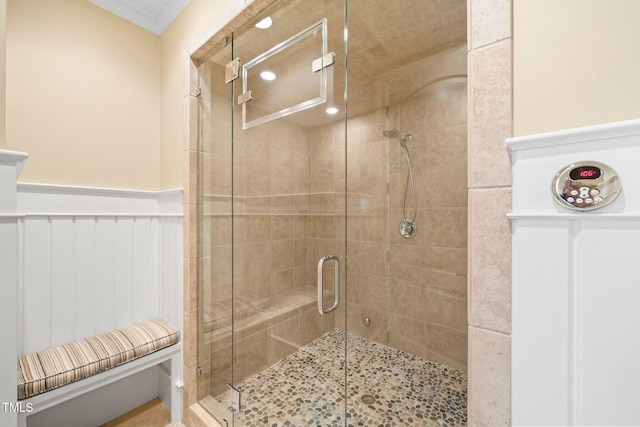 bathroom featuring an enclosed shower and crown molding