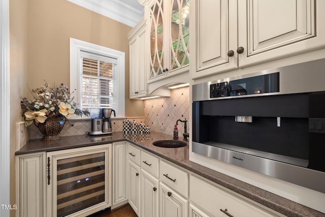 bar featuring sink, tasteful backsplash, crown molding, beverage cooler, and white cabinets